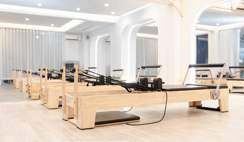 pexels photo 18499500 18499500 Spacious and minimalist pilates studio featuring wooden reformers for fitness workouts.