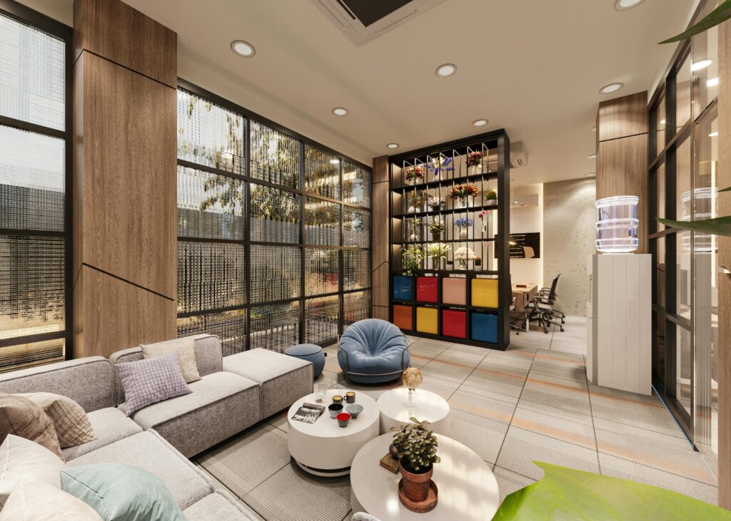 Cozy office lounge featuring modern furniture, large windows, and vibrant decor.